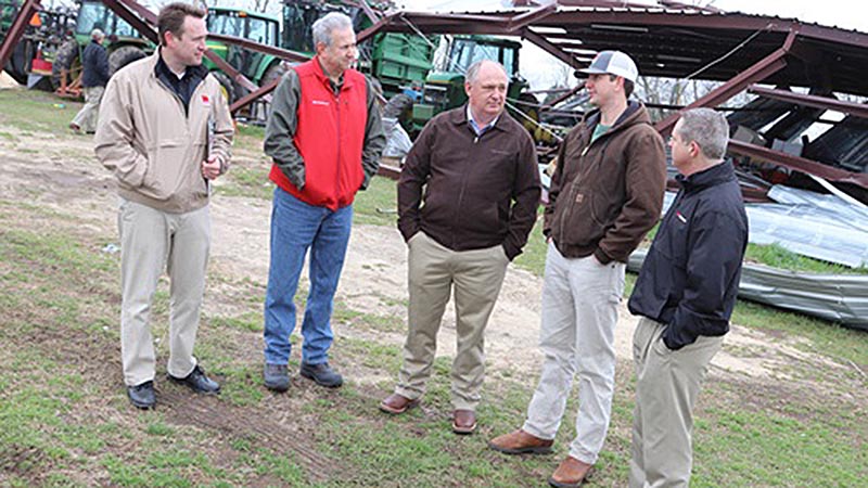 Alfa President, Jimmy Parnell, and staff visiting farm with storm damage